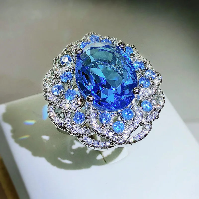 Hot Selling Simulation Sea Blue Topaz Color Treasure Opening Ring Female 925 Stamp Fashion Big Flower Ring Party Wedding Gift